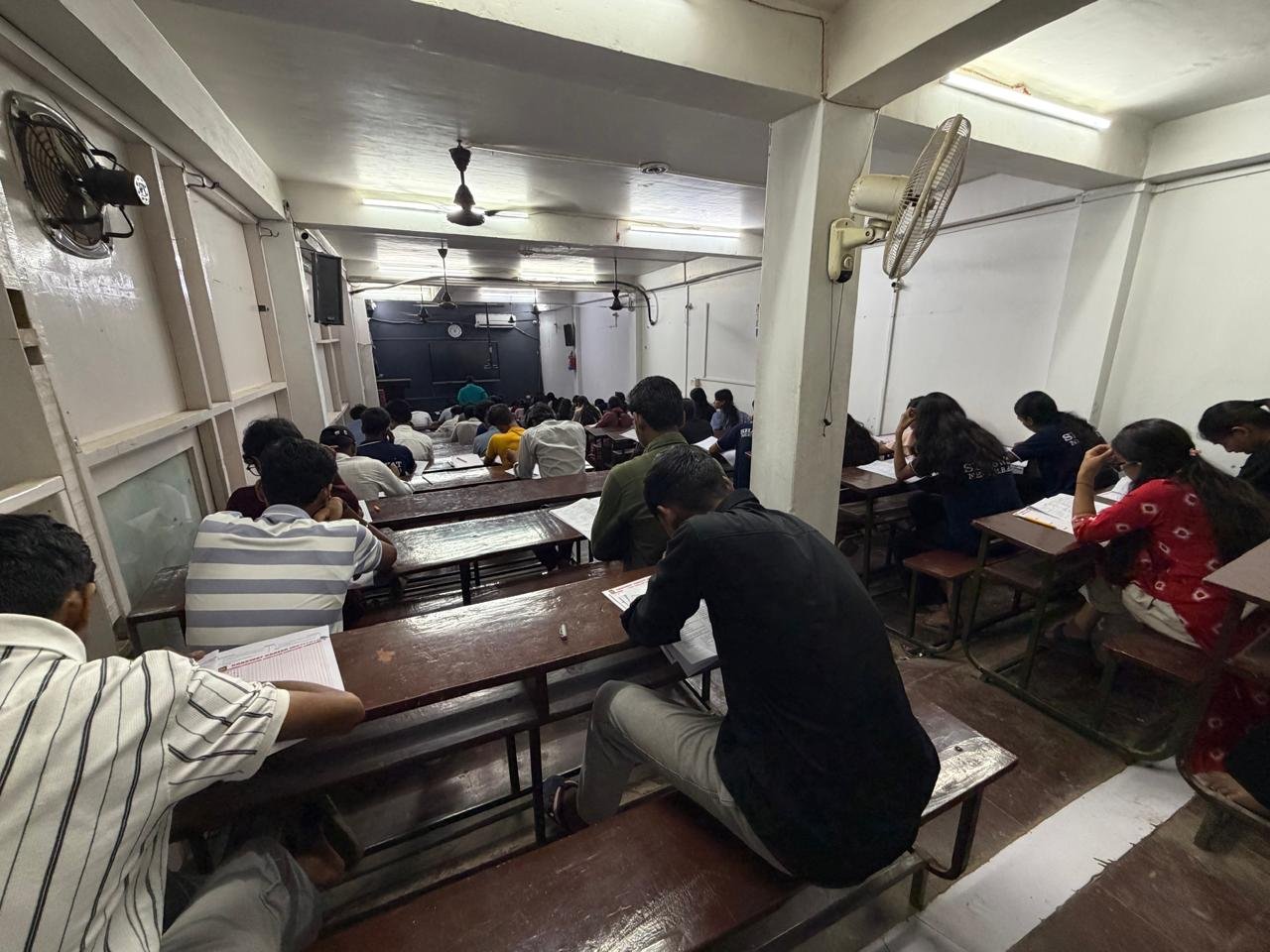 Rear view of students studying at Shaswat Career Institute