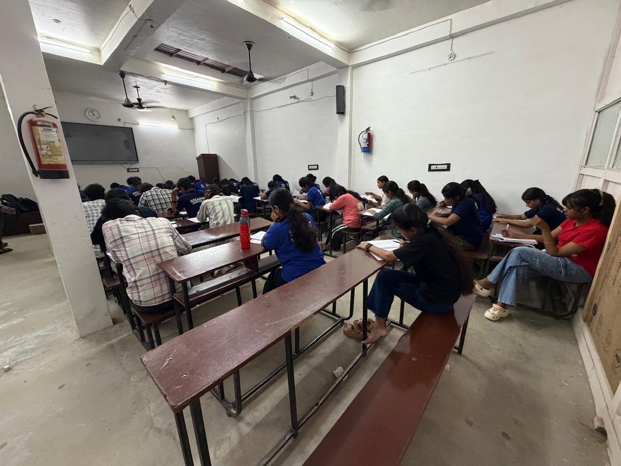 Wide view of students working at desks in the institute classroom