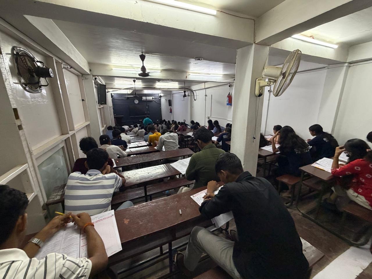 Students writing at their desks during classroom practice